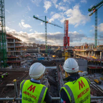 Mercury staff members looking out at a constructiion site