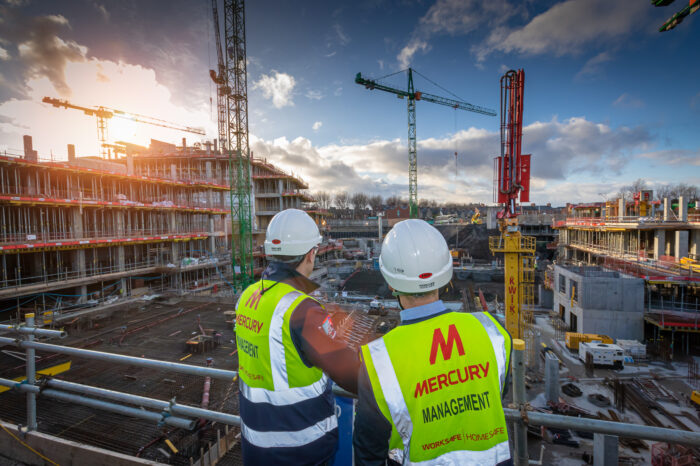 Mercury staff members looking out at a constructiion site