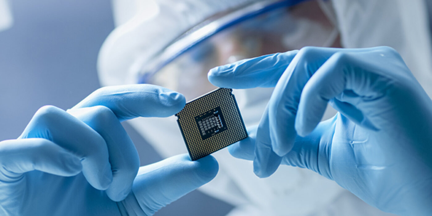 Mercury scientist holding up a semiconductor chip