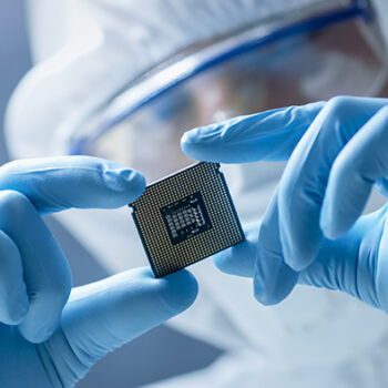 Mercury scientist holding up a semiconductor chip
