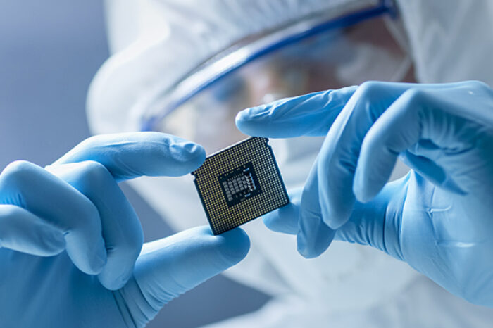Mercury scientist holding up a semiconductor chip
